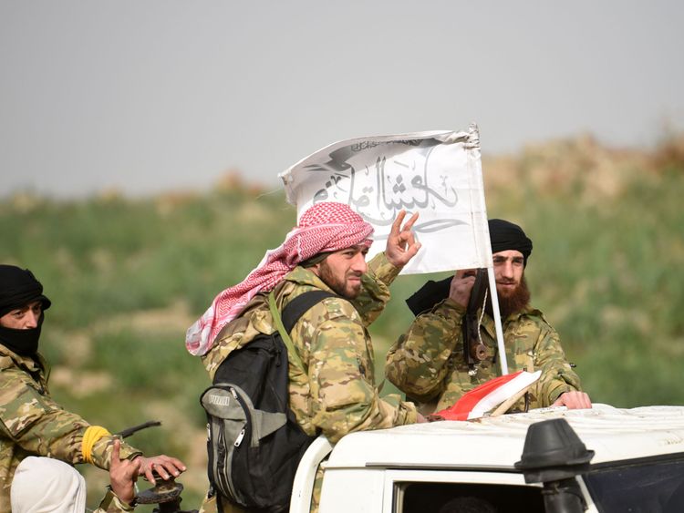 Syrian opposition fighters accompany the Turkish army near the Syria border at Hassa