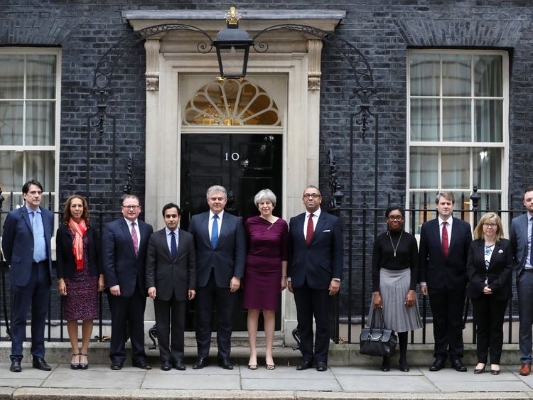 Theresa May poses with Brandon Lewis and James Cleverly and other members of their teams