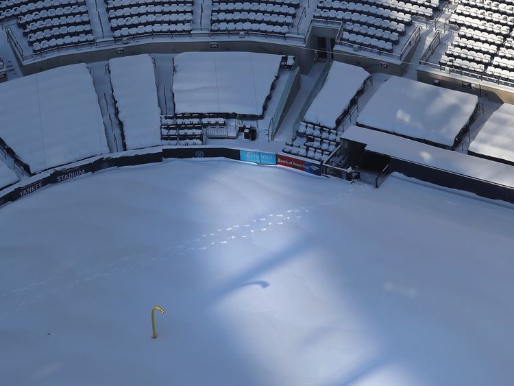 A pair of footprints are seen through a blanket of snow in Yankees Stadium on January 5, 2018 in the Bronx Borough of New York City