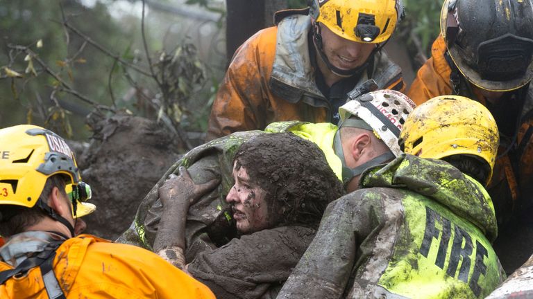 A woman is rescued from a collapsed house in Montecito. Pic: Santa Barbara News-Press