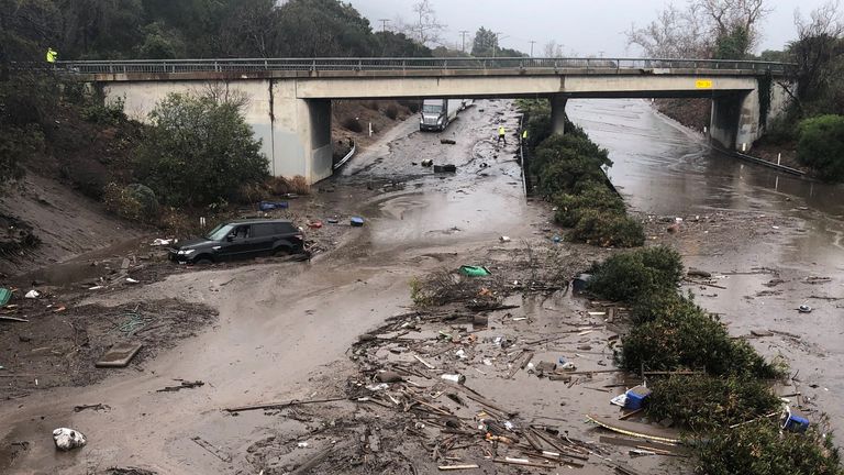 Abadoned cars stuck in flooded water on the freeway after a mudslide in Montecito, California