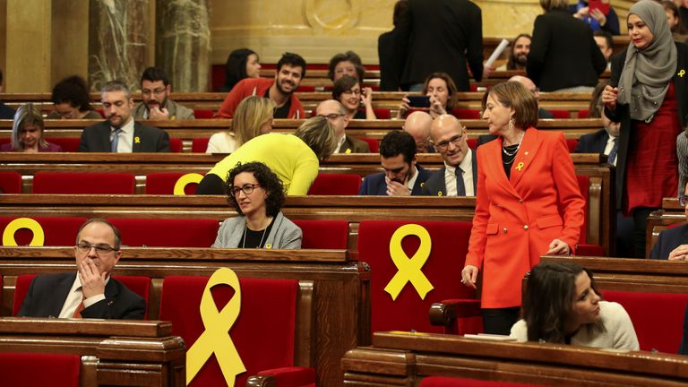 Deputies Jordi Turull, Marta Rovira and Carme Forcadell take their seats before the start of the first session of Catalan Parliament after regional elections