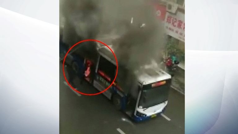 The man is pulled from the burning bus