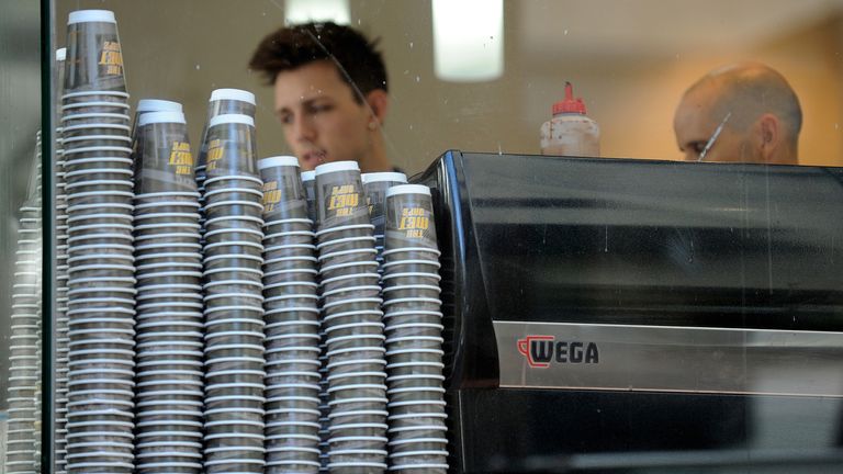 Take-away coffee cups are displayed alongside a coffee machine at the &#39;Met Cafe&#39;, one of the most popular cafes in the central business district of Sydney on April 20, 2010