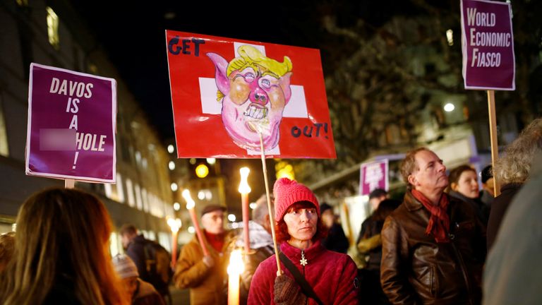 People attend an Anti-Trump demonstration to protest U.S. President&#39;s coming to the World Economic Forum of Davos, in Geneva