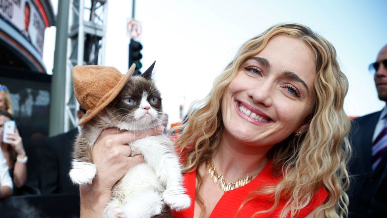 Grumpy Cat arrives with his owner Tabatha Bundesen at the 2014 MTV Movie Awards in Los Angeles, California April 13, 2014