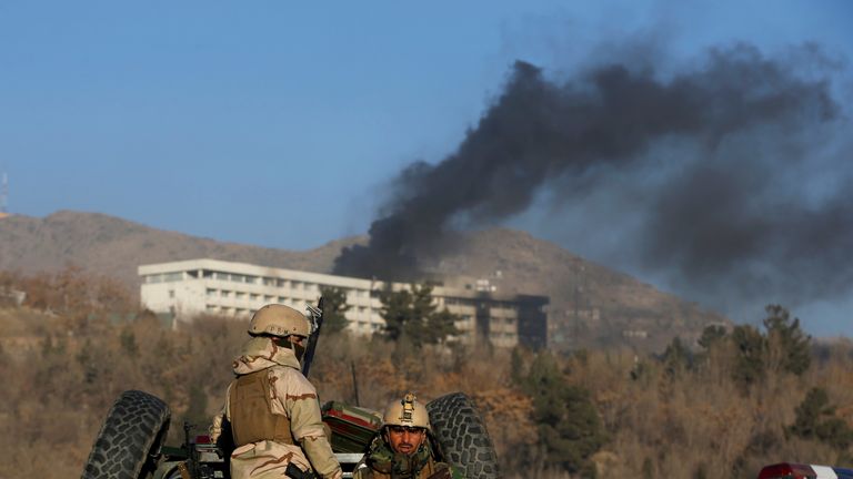 Afghan security forces keep watch as smoke rises from the Intercontinental Hotel in Kabul, Afghanistan January 21, 2018