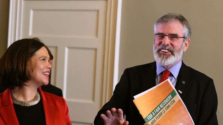 Sinn Fein leader Gerry Adams laughs as Mary Lou McDonald watches after a pre-election news conference in Dublin, Ireland February 24, 2016