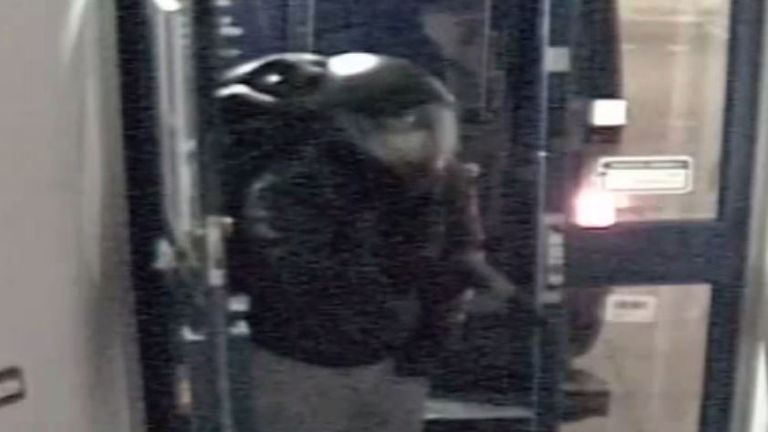 The moment a suspect held a bank security at gun-point Pic: Met Police