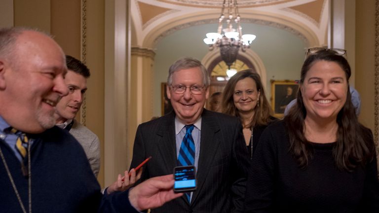 Mitch McConnell (centre) could not stop the shutdown entering a new week