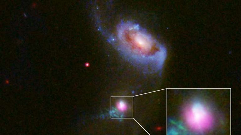 Bright light from gas the black hole is accreting. Pic: NASA , ESA, and J. Comerford (University of Colorado-Boulder)
