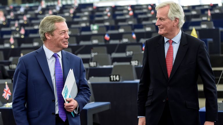 Michel Barnier speaks with MEP and former UKIP leader Nigel Farage at the European Parliament