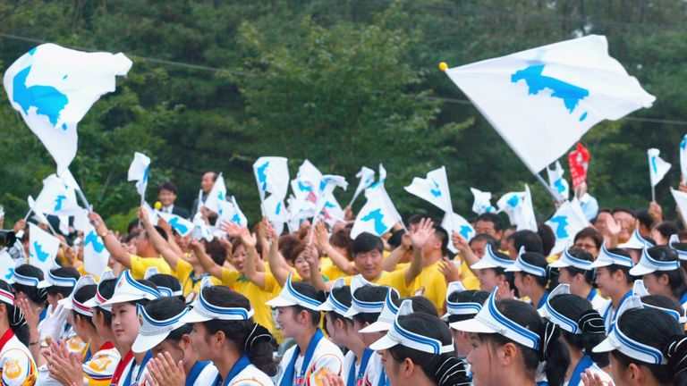 South Korean supporters wave unified Korean peninsula flags at the World Student Games in 2003