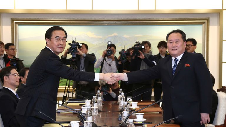North Korean and South Korean negotiators shake hands during Tuesday's rare talks