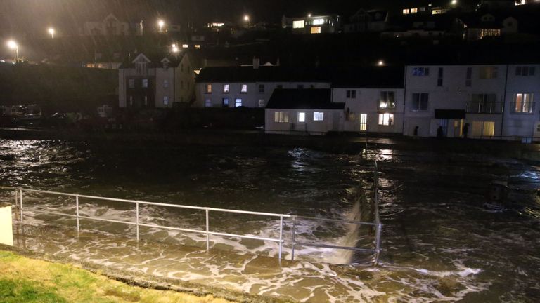 Waves hit rocks in Portreath as storm-force winds caused high tides and flooding