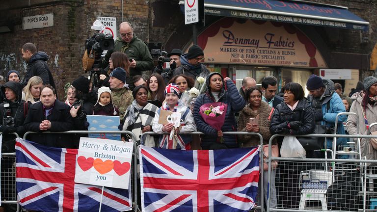 People wait for the arrival of Prince Harry and Meghan Markleat Reprezent FM, in Brixton, south London 