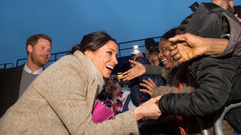 Britain&#39;s Prince Harry (L) and fiancée US actress Meghan Markle meet well-wishers as they leave after a visit to Reprezent 107.3FM community radio station in Brixton, south west London on January 9, 2018. During their visit to the station, they met some of the presenters, content producers and staff, heard more about their training programmes, and met some of the current and former volunteers who have benefitted from the training. / AFP PHOTO / POOL / Dominic Lipinski (Photo credit should read D