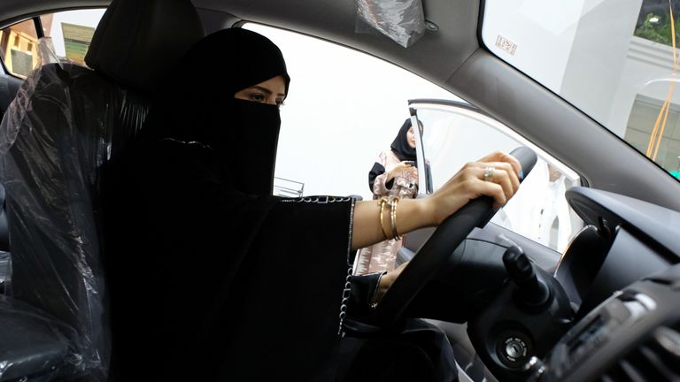 A woman sits behind the wheel at the show in Jeddah