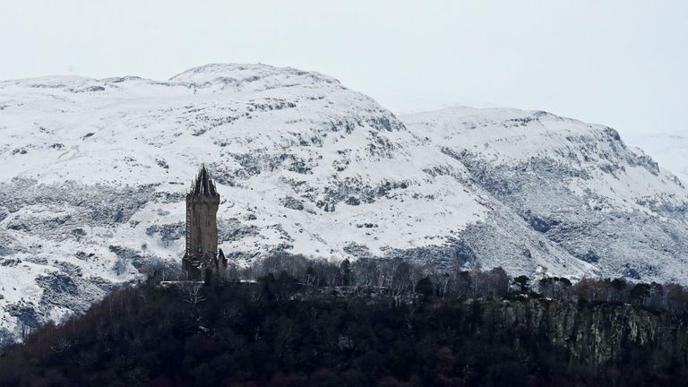 The snow-covered Ochil Hills behind the Wallace Monument in Stirling