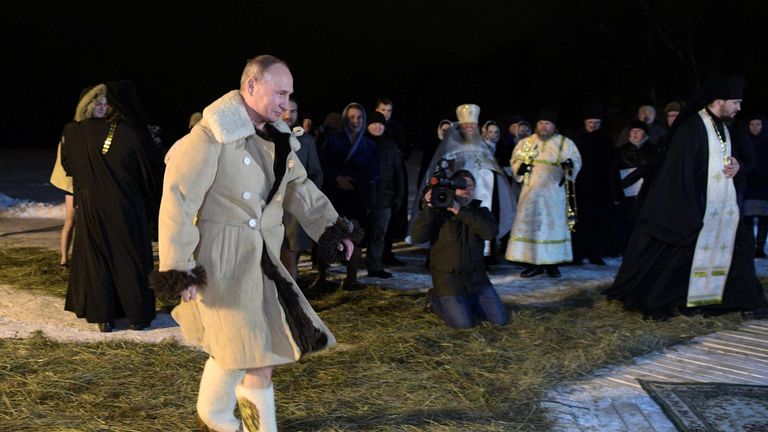 Russian President Vladimir Putin walks to take a dip in the water during Orthodox Epiphany celebrations at lake Seliger, Tver region, Russia