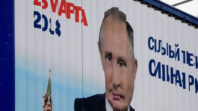 A rotating billboard shows an image of Russia&#39;s President Vladimir Putin and lettering &#39;18 March 2018&#39; in Moscow on January 15, 2018