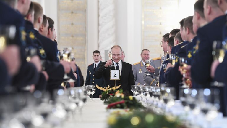Russian President Vladimir Putin toasts with attendees after a state awards ceremony for military personnel who served in Syria, at the Kremlin in Moscow, Russia December 28, 2017