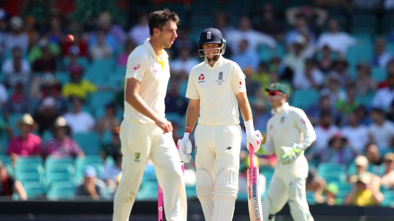 SYDNEY, AUSTRALIA - JANUARY 07: Joe Root of England smiles at Pat Cummins of Australia after facing a delivery from him during day four of the Fifth Test m