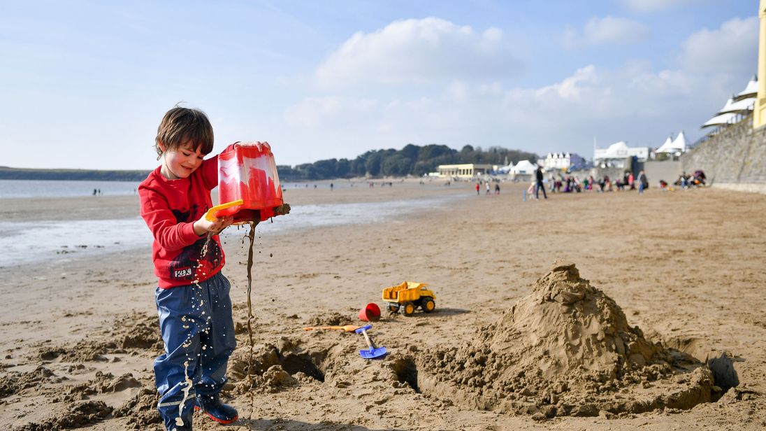 Jimi Cooke, 5, from Vale of Glamorgan, plays on Barry Island beach in South Wales during sunny weather as temperatures remain in single figures