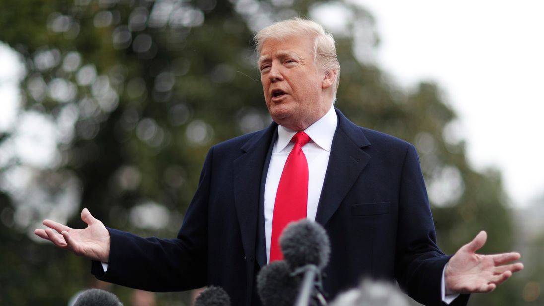 Donald Trump takes questions from reporters before departing the White House in Washington