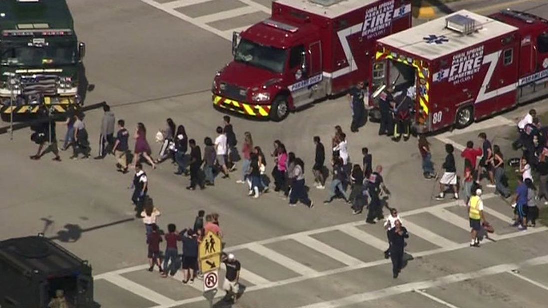 RTX4WX8814 Feb. 2018PARKLAND, UNITED STATESStudents are evacuated from Marjory Stoneman Douglas High School during a shooting incident in Parkland, Florida, U.S. February 14, 2018 in a still image from video. WSVN.com
