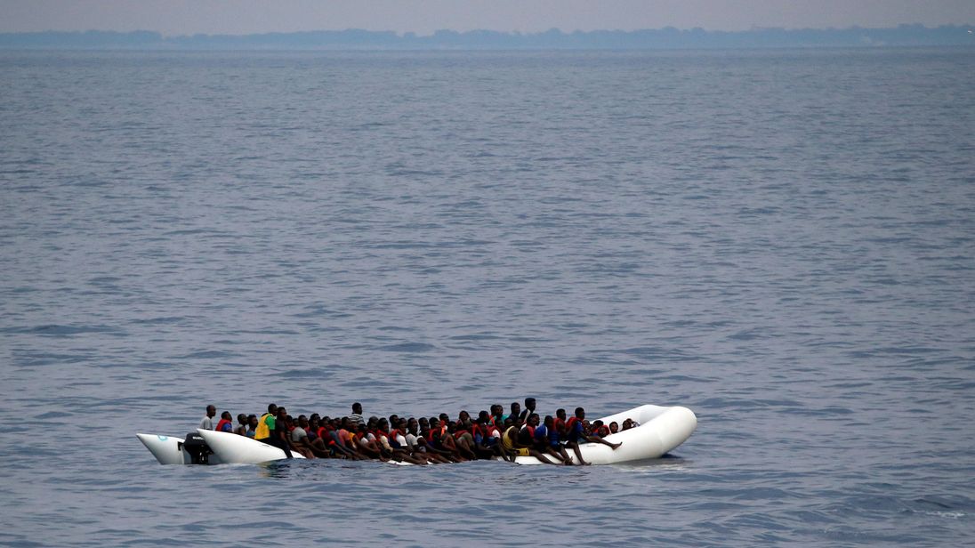 Migrants on a dinghy are seen being rescued by "Save the Children" NGO crew from the ship Vos Hestia in the Mediterranean sea off Libya coast