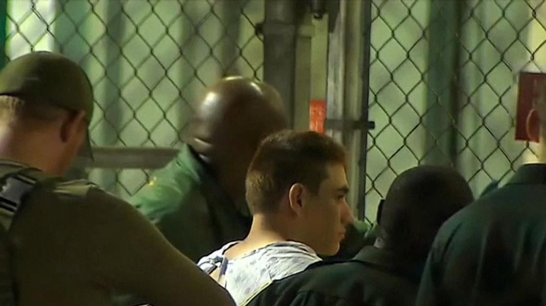 Police leading Florida school shooting suspect Nikolas Jacob Cruz into jail