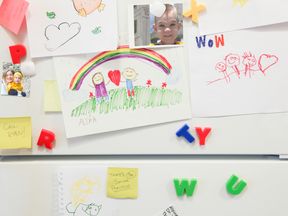 Fridge covered in family pictures and artwork.  File pic.