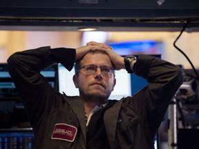 A trader is shown on the floor of the New York Stock Exchange at the closing bell on Monday