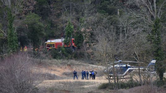 French gendarmes and firefighters work at the site of an accident near Carces lake, about 50 kilometres (30 miles) northwest of the resort of Saint-Tropez