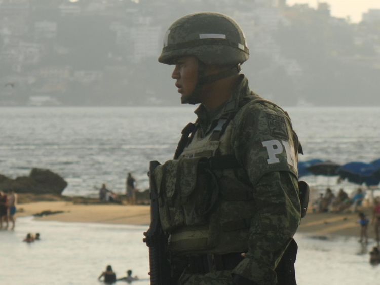 A police office guards the beach in Acapulco