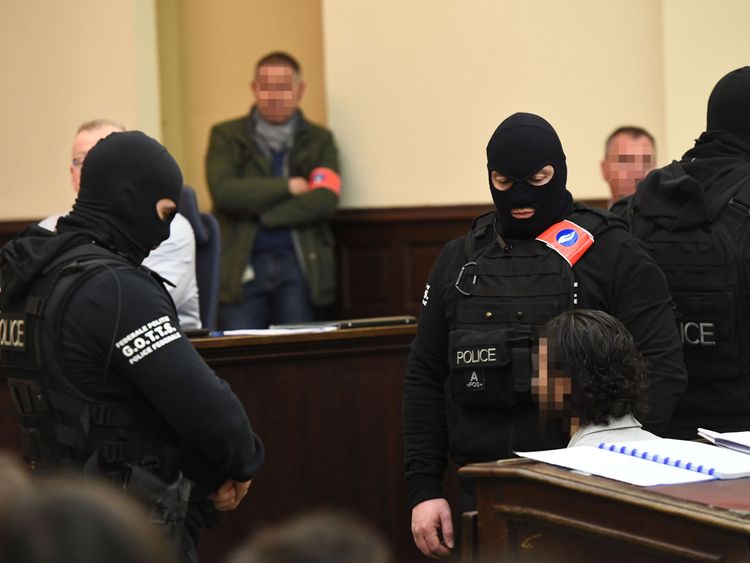 Salah Abdeslam surrounded by special police officers in the Palais de Justice