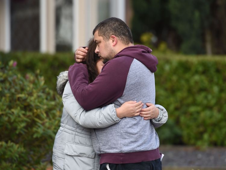 Reese Platt-May, the father of the brothers, hugs his sister Tia Fletcher close to the scene on Friday