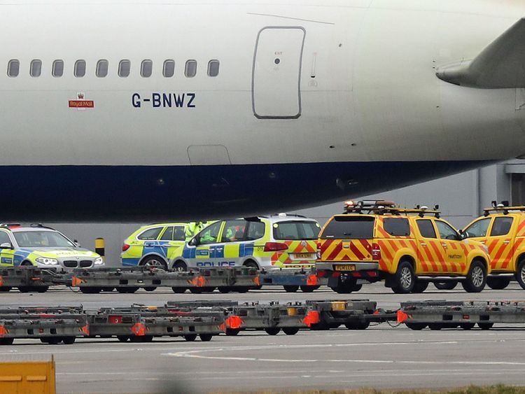 Police and airside operations vehicles at Heathrow Airport after a man died following an accident on the airfield