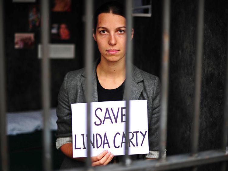 An employee of legal action charity, Reprieve holds a sign which reads 'Save Linda Carty' during a protest in a mock prison cell, in London on August 12, 2010. The charity has created a life-size death row cell which they are encouraging visitors to spend 15 minutes in. The event is designed to highlight the plight of British prisoner, Linda Carty who is on death row in the U.S after she was convicted for comitting a murder on May 16, 2001. The cell will be on show from August 12, 2010 to Septem