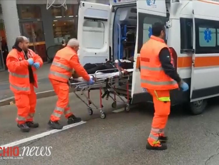 An injured person is taken in an ambulance after the shootings
