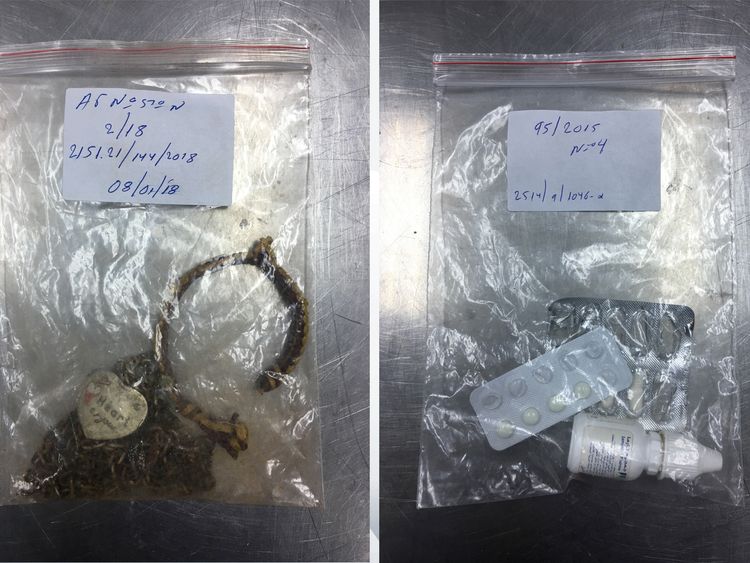 A bracelet with a heart pendant, and medication