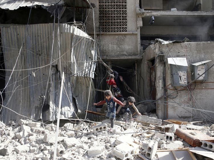 Children play in the rubble after the strikes