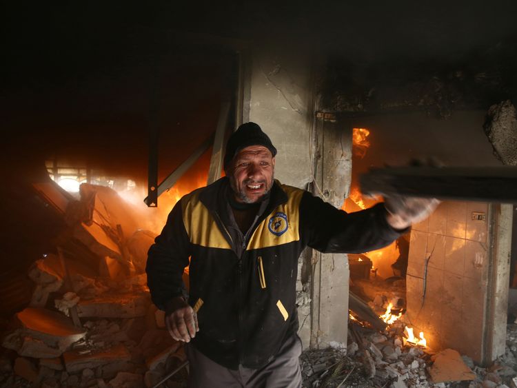 A man makes his way through the rubble after the Syrian government&#39;s latest round of airstrikes