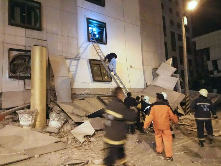 Rescue workers search through rubble outside the Marshal Hotel in Hualien, eastern Taiwan early February 7, 2018, after a strong earthquake struck the island. A hotel on the east coast of Taiwan has collapsed after a 6.4-magnitude earthquake, the government said. / AFP PHOTO / STR / Taiwan OUT (Photo credit should read STR/AFP/Getty Images)