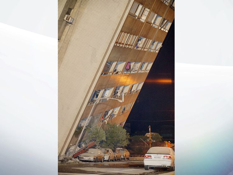 The building was seen balancing precariously over the road and some parked cars