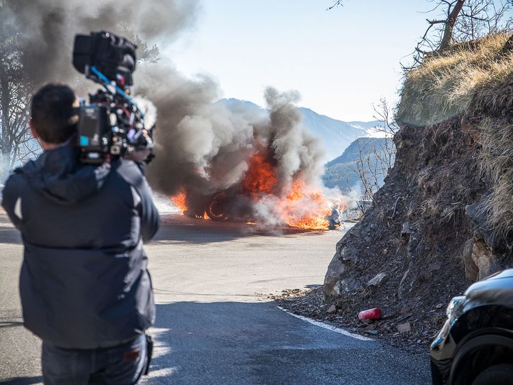The crew film the blazing car
