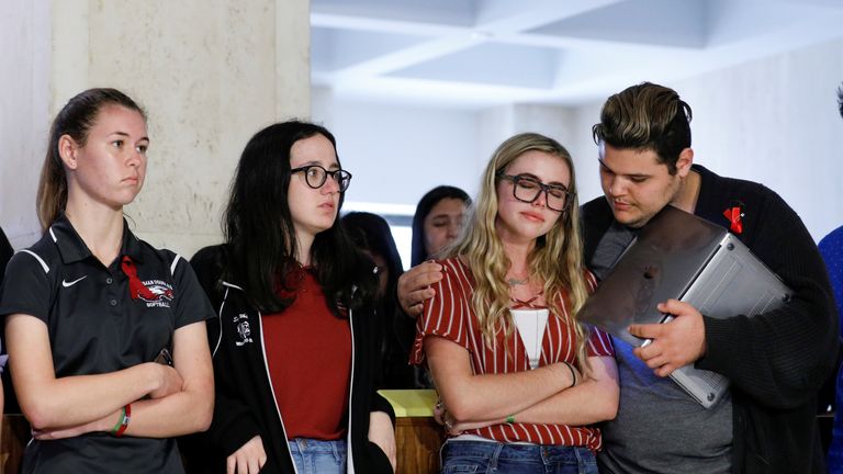 Demitri Hoth (R) consoles fellow Marjory Stoneman Douglas High School student Delaney Tarr