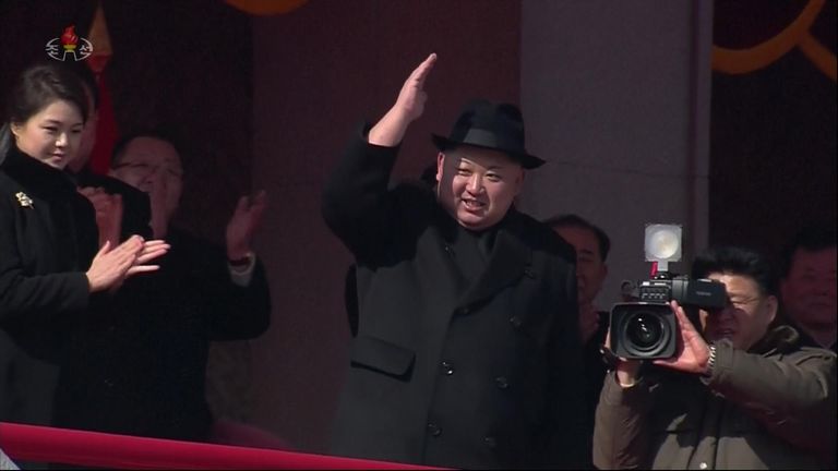Km Jong Un salutes troops during a military parade in North Korea, flanked by his wife Ri Sol Ju