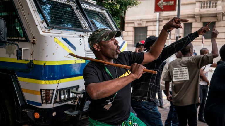 Supporters of the ANC Deputy President Cyril Ramaphosa dance and chant slogans during a demonstration outside the ANC party headquarter in Johannesburg
